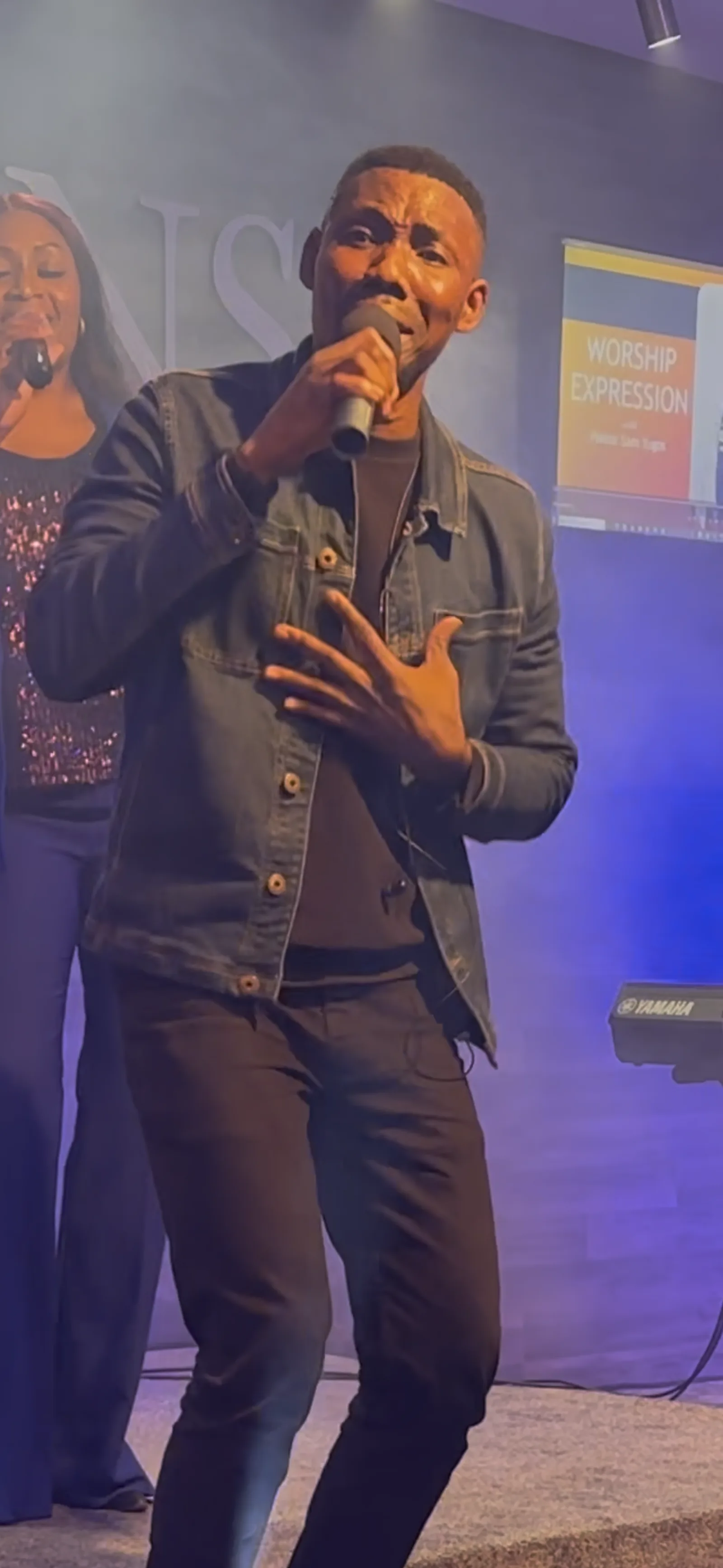 Sam Yugos ministering in worship on stage